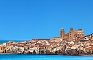 Houses along the shoreline and cathedral in background, Cefalu, Sicily