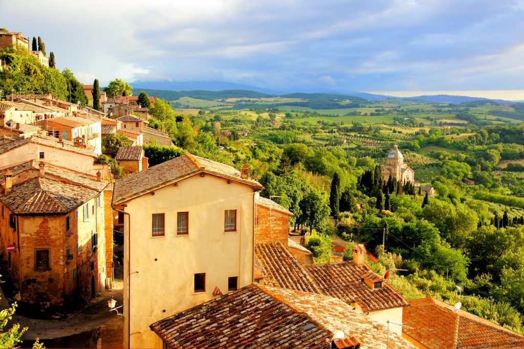View over the Tuscan countryside and the town of Montepulciano at sunset, Italy