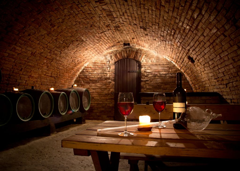 Wine cellar with wine bottle and glasses, Italy